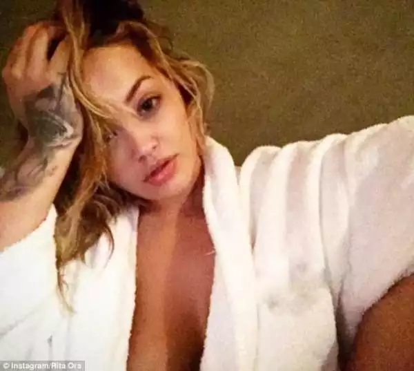 Braless Rita Ora puts on a very busty display in a revealing robe
